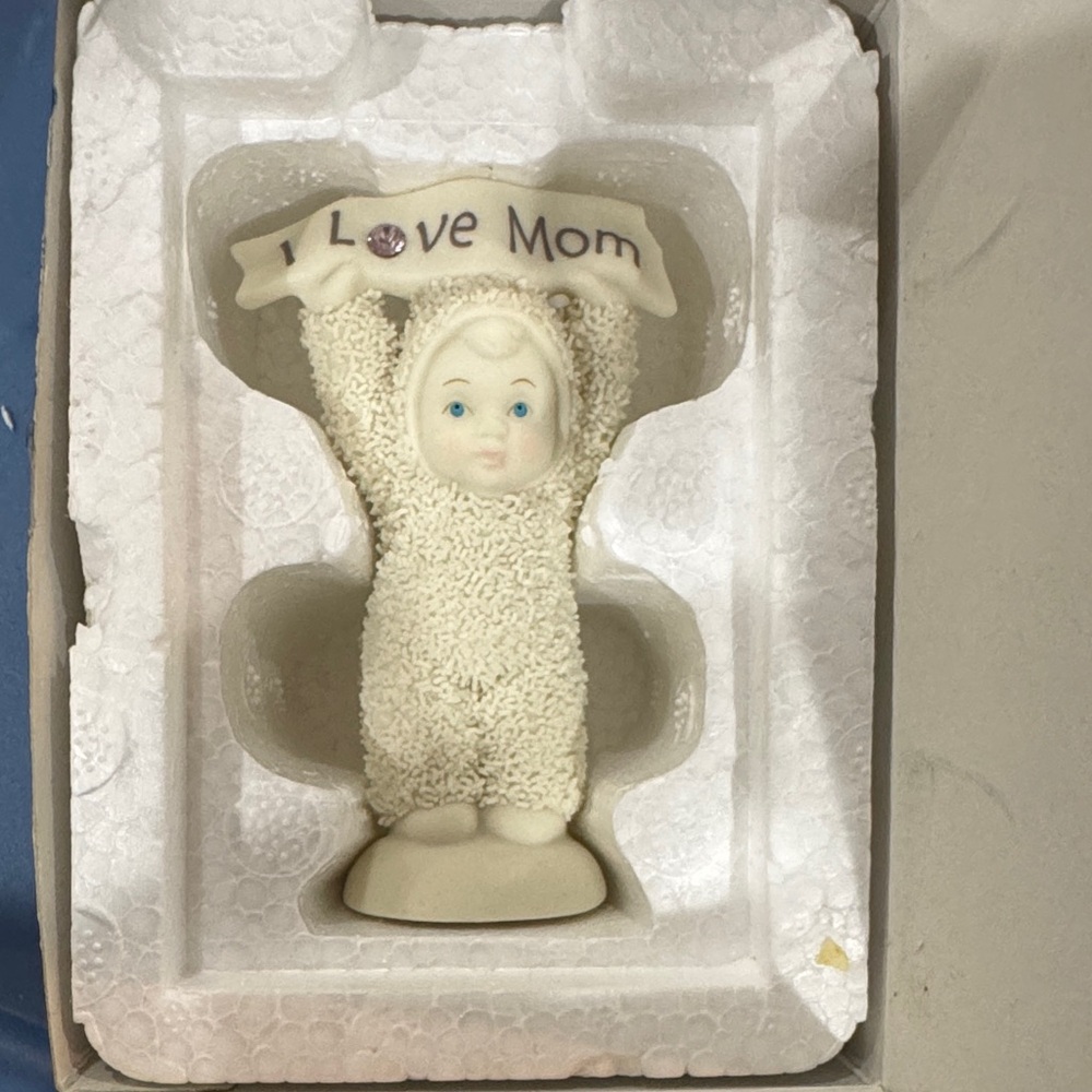 Department 56 Cream Baby Figurine Holding "I Love Mom" Banner with Blue Accents
